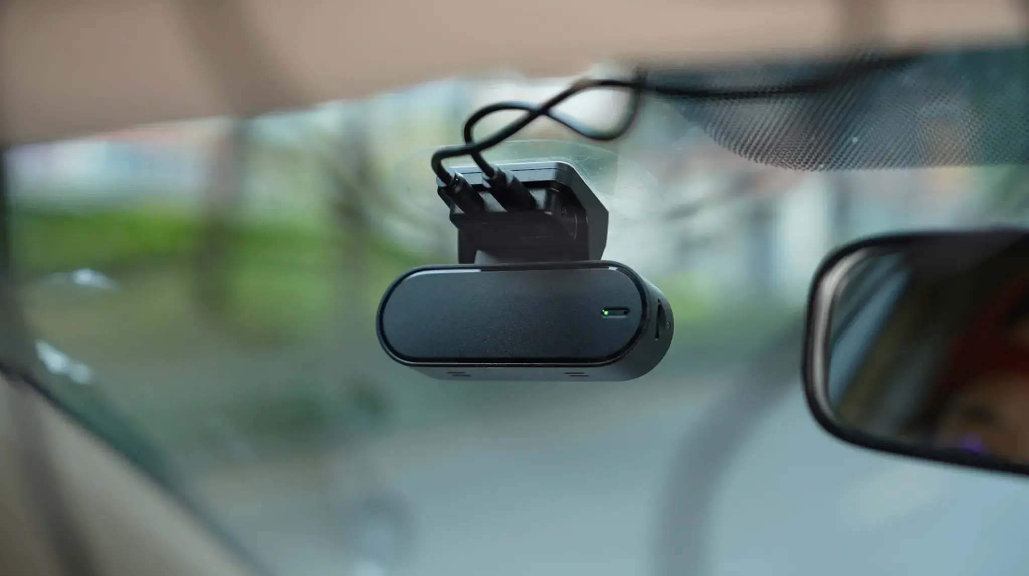 DDPAI N5 Dual 4K dash cam mounted on car windshield capturing the road view.