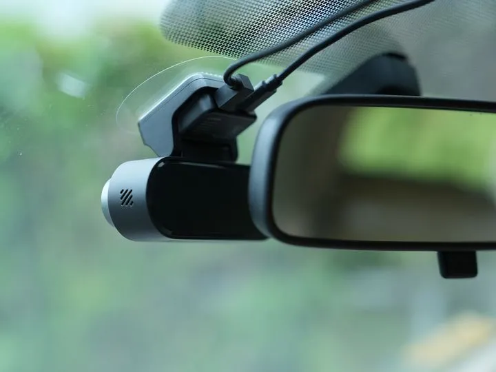 DDPAI N5 Dual dash cam securely mounted on a car's windshield next to the rearview mirror.
