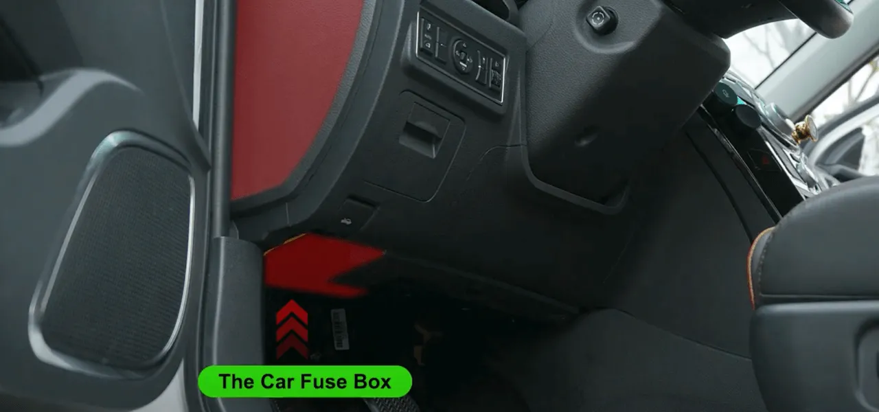 Identifying the location of the car fuse box under the dashboard.